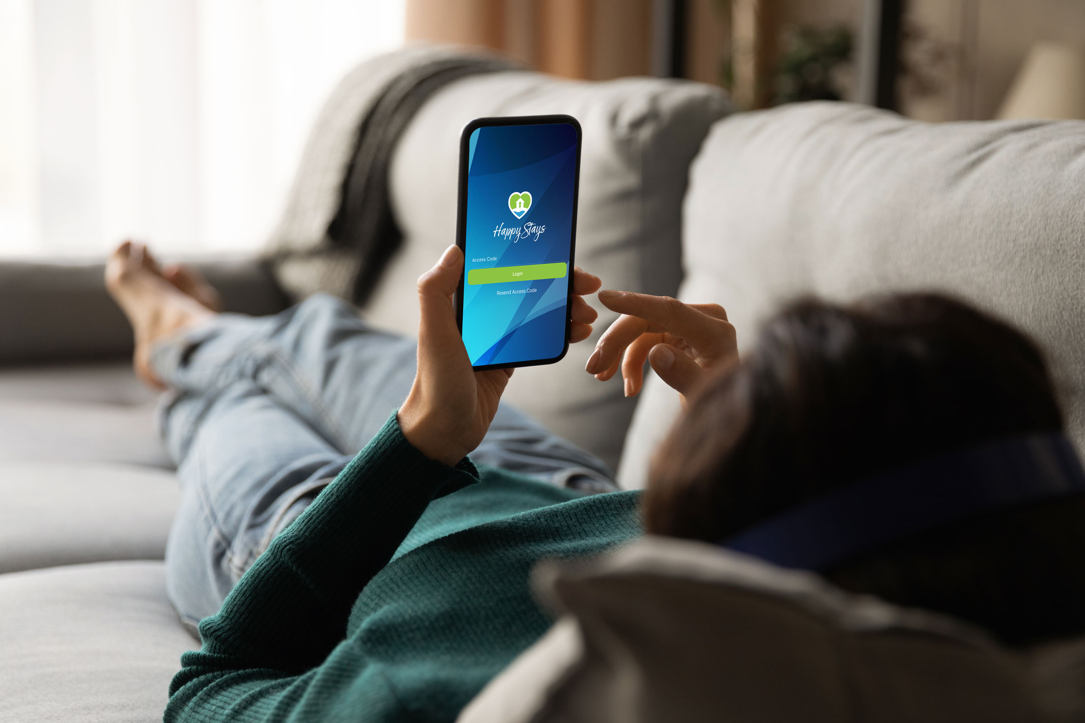 a person lying on a couch holding a phone